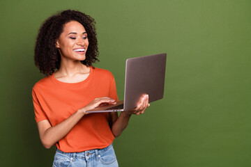 Canvas Print - Photo of adorable pretty woman wear orange t-shirt working modern gadget empty space isolated green color background