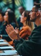 © BraveSpirit - Close-up of people applauding at a business conference with a blurred background