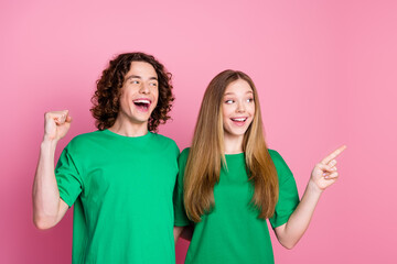 Sticker - Photo of youth teammates wearing green t shirt winning and point finger empty space college competition isolated on pink color background