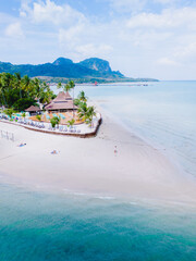 Wall Mural - Drone aerial top view at Koh Muk a tropical island with palm trees and soft white sand, and a turqouse colored ocean in Koh Mook Trang Thailand