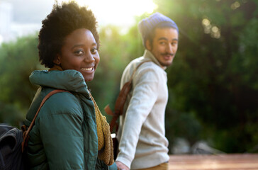 Canvas Print - Holding hands, park and happy interracial couple together with smile, bag and morning commute to university. College, students and romance in nature, man and woman with diversity, mockup and love.