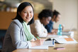 © Nicola K/peopleimages.com - Student, portrait and library studying with book at desk for university or education for future, exam or scholarship. Asian person, writing and college degree in Korea for academic, campus or test