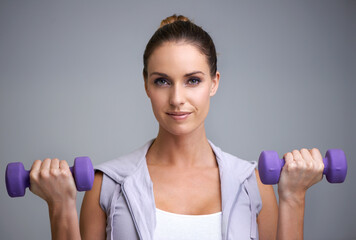 Sticker - Happy woman, portrait and dumbbells for weightlifting, fitness or exercise on a gray studio background. Face of active, female person or athlete for strength, muscle gain or workout on mockup space