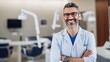 Dental Center. Portrait Of Smiling Middle Eastern Dentist Doctor Posing At Workplace, Handsome Arab Stomatologist Standing With Folded Arms In Modern Clinic Interior, Ready For Check Up