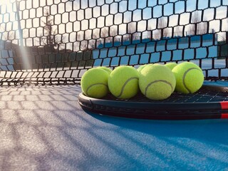 tennis balls on racket on the tennis court close up shot