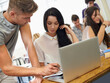 © Jeff Bergen/peopleimages.com - Serious, students and friends help on laptop, learning and knowledge in university for education. Team, man and woman in college at desk with paper for info, test or study for exam together in class