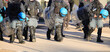 police in riot gear during the protest demonstration with helmets and shields on the road