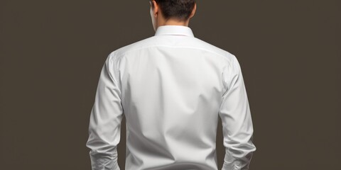 Poster - A man wearing a white shirt stands with his hands casually placed in his pockets. This versatile image can be used to depict relaxation, confidence, or a casual business setting