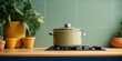 A pot sitting on top of a stove next to potted plants. Suitable for home decor or cooking-related content
