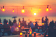 © Hunman - Blurred people having sunset beach party in summer vacation.
