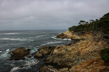 Wall Mural - Picturesque view featuring a rocky shoreline extending out to the horizon