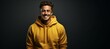 © Wirestock - Portrait of a handsome young man in a yellow sweater standing on a dark background, AI-generated.