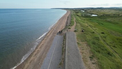 Wall Mural - Ascending drone over wetland coast by the sea and blue sky on the horizon