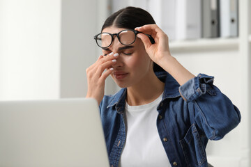 Wall Mural - Woman suffering from headache at workplace in office