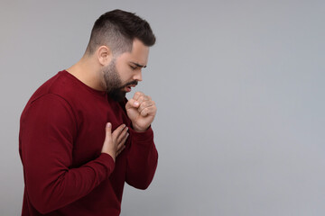 Sticker - Sick man coughing on gray background, space for text