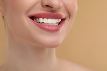 Sticker - Young woman with beautiful smile on beige background, closeup