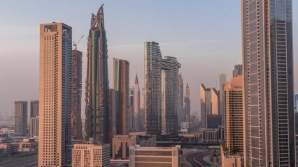 Wall Mural - Futuristic towers and skyscrapers with traffic on streets in Dubai Downtown and financial district during all day. Urban city skyline aerial timelapse with shadows moving fast until sunset