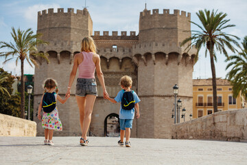 Wall Mural - Mother with kids walk in front of famous Torres de Serrans