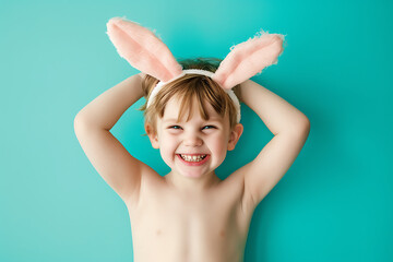 Wall Mural - Happy little boy wearing easter rabbit headband with ears on background.