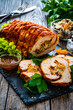 © Jacek Chabraszewski - Stuffed turkey breast roulade with dried apricots and cranberries on wooden table