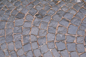 Gray retro paving stones in the city, tiles, cobblestones, background, texture. Design.