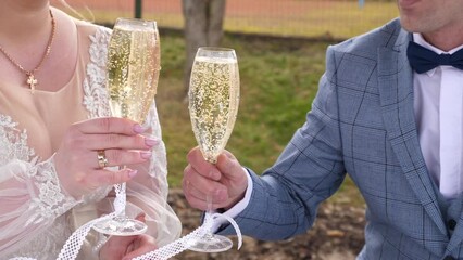 Wall Mural - Newlyweds raise glasses of champagne, celebrating their marriage.