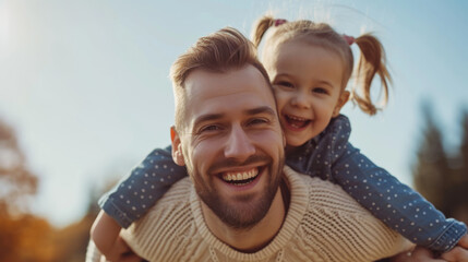 Sticker - joyful father is carrying his happy little daughter on his shoulders during a sunny autumn day.