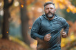 Overweight man jogging in the park.