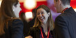 © RemsH - meeting within a company, networking at a reception, group of employees, businesswomen chatting at a networking event, sharing and chatting with a smile