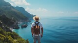 Fototapeta Most - A man stands with her back and admires the view of the sea and mountains. A traveler traveling on vacation in the most beautiful place in the world. Summer vacation