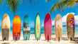 lineup of colorful surfboards standing upright on a sandy beach with palm trees in the background