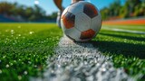Fototapeta Sport - Close-up of a Leg in a Boot Kicking Football Ball. Professional Soccer Player Hits Ball