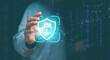 © krungchingpixs - Cyber security and data protection, Businessman holding icon padlock and shield in hand with binary background. Privacy business internet technology. Protection data from hacker or cyber crime.