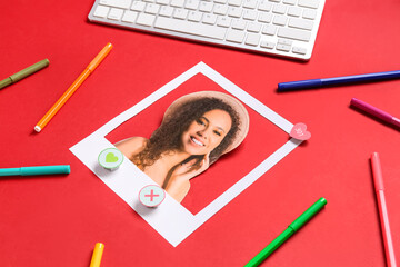 Wall Mural - Photo of beautiful woman with computer keyboard and markers on red background. Concept of online dating