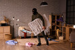 © Pixel-Shot - Male thief stealing painting in room at night