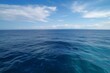 A vast expanse of blue sea stretching to the horizon. Generative AI