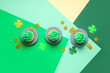 canvas print picture - Plates with tasty cupcakes and decor for St. Patrick's Day on color background