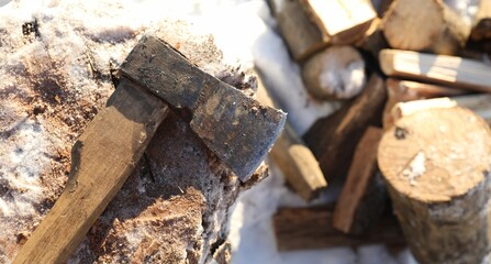 Wall Mural - Metal axe on wooden log and pile of wood outdoors on sunny winter day, top view. Space for text