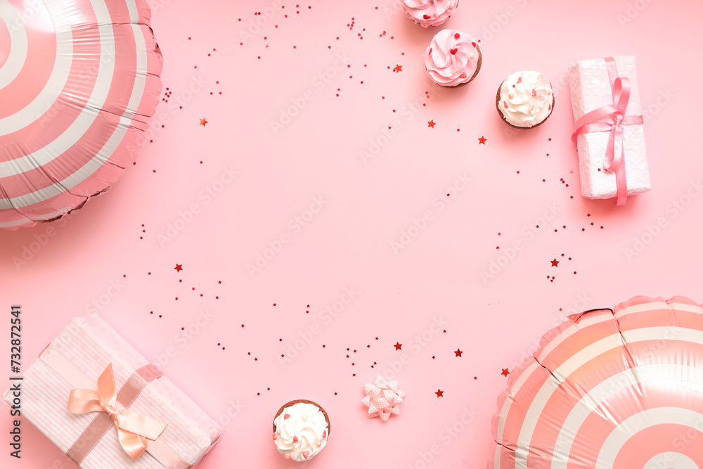 Balloons with gift boxes and cupcakes on pink background