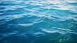 Blue green surface of the ocean in Catalina Island California with gentle ripples on the surface and light refracting