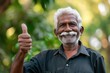 © VolumeThings - Elderly Indian man at park giving a thumbs up happy white haired senior with positive emotion