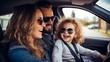 A beautiful young family with a little boy is having fun and smiling in their new car.