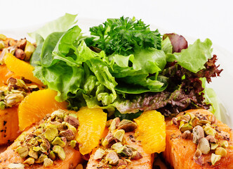 Wall Mural - salmon with pistachios, orange slices and lettuce