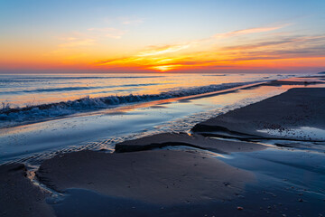 Wall Mural - Brightly colorful sunrise on the sea coast