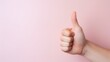 © Mr. Muzammil - Hand of business man showing thumbs up on pink background with copy space