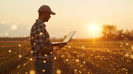 Application of new technologies in agribusiness. The farmer uses a laptop on the background of the field 