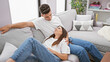 © Krakenimages.com - A loving couple relaxes in a modern living room, portraying companionship and a cozy home atmosphere.