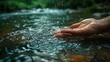 hand gently touching water in river flow
