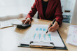 © Witoon - Asian businesswoman in a formal suit in the office with a laptop computer