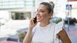 © Krakenimages.com - Young blonde woman speaking on the phone at street